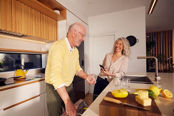 Couple chatting in kitchen.