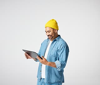 Happy man checking his power usages on his tablet