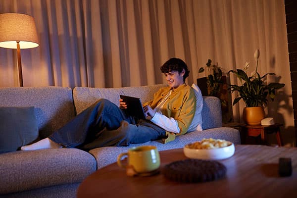 Teenager lounging with iPad.