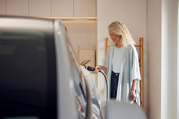 Women charging EV.