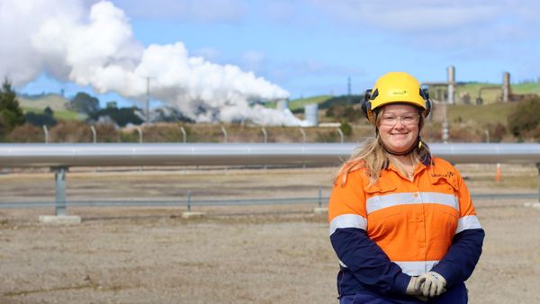 Woman in PPE stood in front of Geothermal Power station