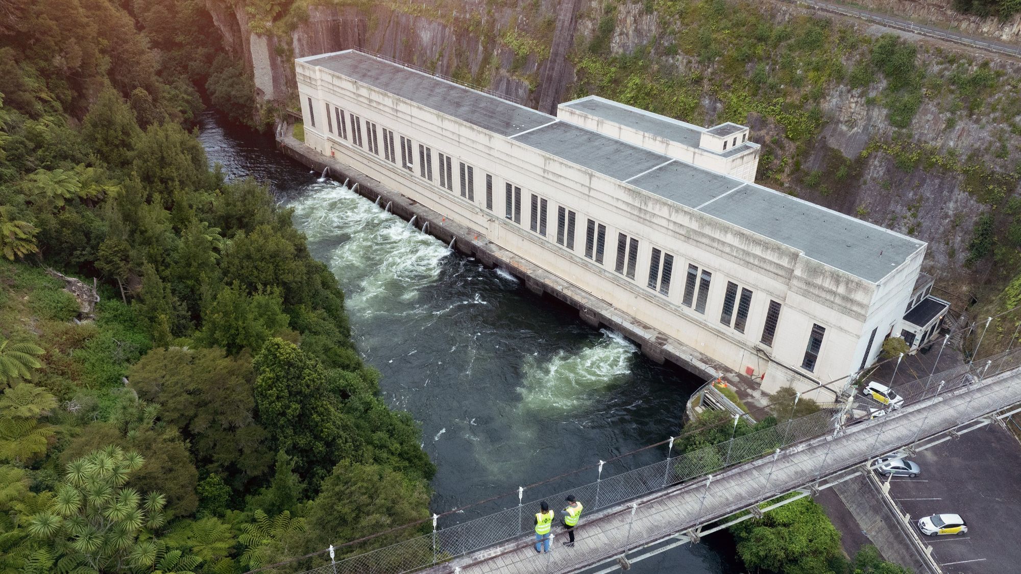 Aerial photo of Arapuni Hydro Station with two people on bridge overlooking it