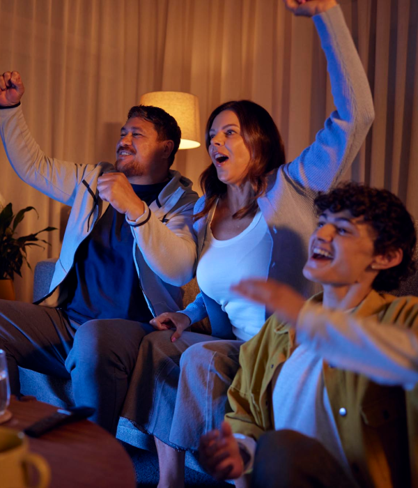 Family Cheering while watching TV at night